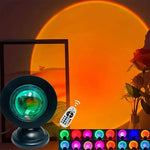 16-color sunset projection lamp creating warm ambient lighting in a modern bedroom with remote-controlled LED color-changing effects.