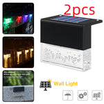 Waterproof RGB solar fence and step light illuminating outdoor garden pathway with color-changing LED lighting and crystal-style design.