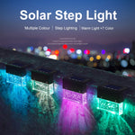 Waterproof RGB solar fence and step light illuminating outdoor garden pathway with color-changing LED lighting and crystal-style design.