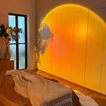 360-degree rotating LED sunset projection lamp creating warm ambient lighting in a modern bedroom and living room decor setting
